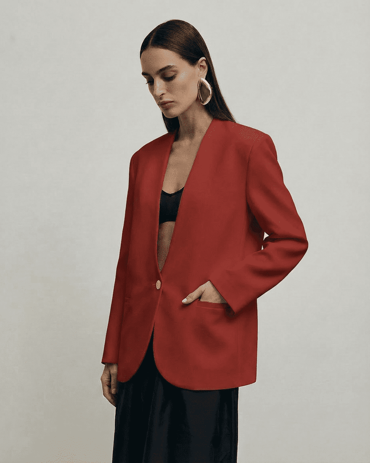 Carmine Blazer by Lauven worn by a model, showcasing its fitted silhouette and deep V-neckline in a rich red tone.