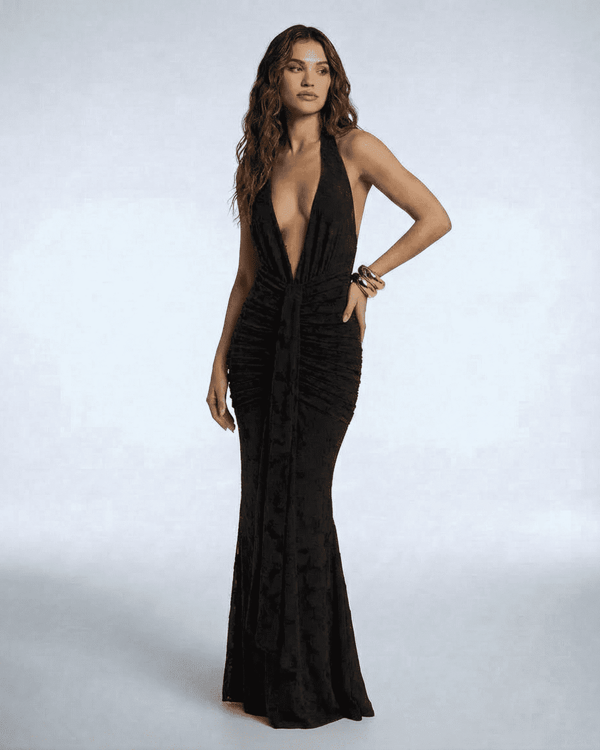 Celeste Maxi Dress by Lauven, black sleeveless ruched bodycon mermaid gown with deep V-neckline and tie-up ribbon detail.