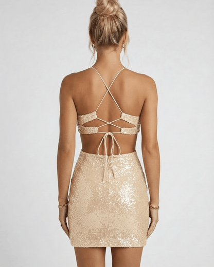 Back view of woman wearing Celeste Mini Dress by Lauven, showcasing champagne sequins and stylish cutout design.