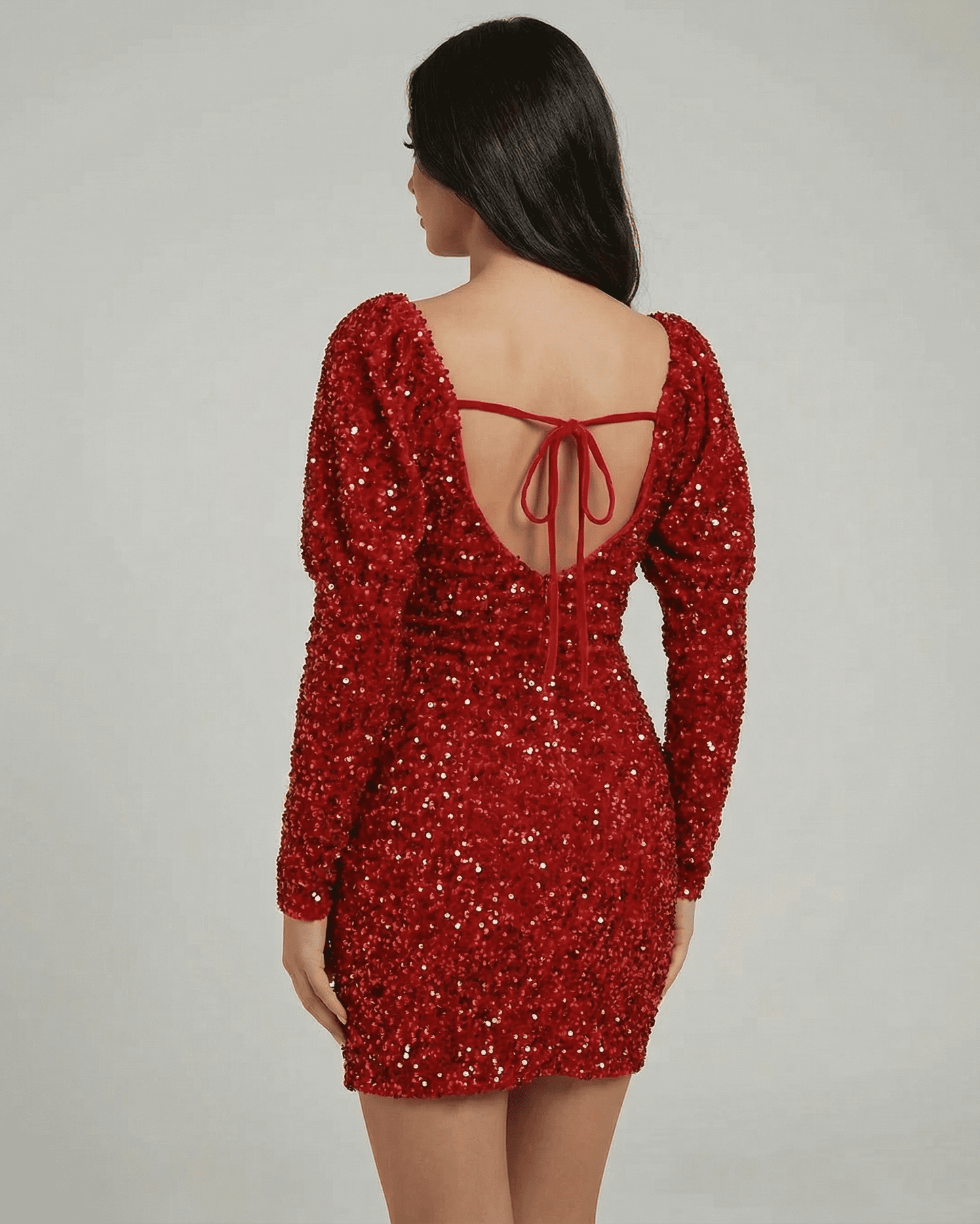 Celeste Mini Dress by Lauven, showcasing a dazzling red sequin finish and elegant styling from the back view.