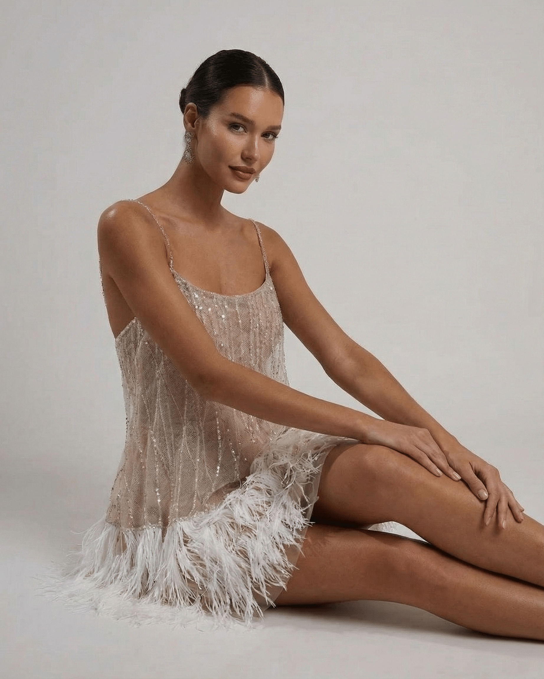 Celeste Mini Dress by Lauven, a sequin tulle fairycore mini dress with feather tassel hem, showcasing elegance and shimmer.