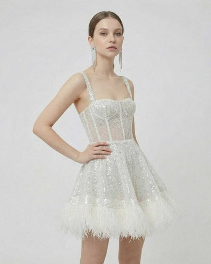 Celeste Mini Dress by Lauven featuring silver sequins and faux fur hem, highlighting an A-line silhouette.