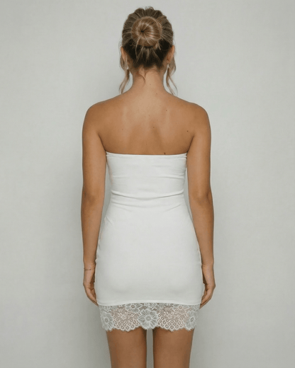 Back view of a woman wearing the Lauven Celeste Mini Dress, showcasing the strapless design and lace hem detail.