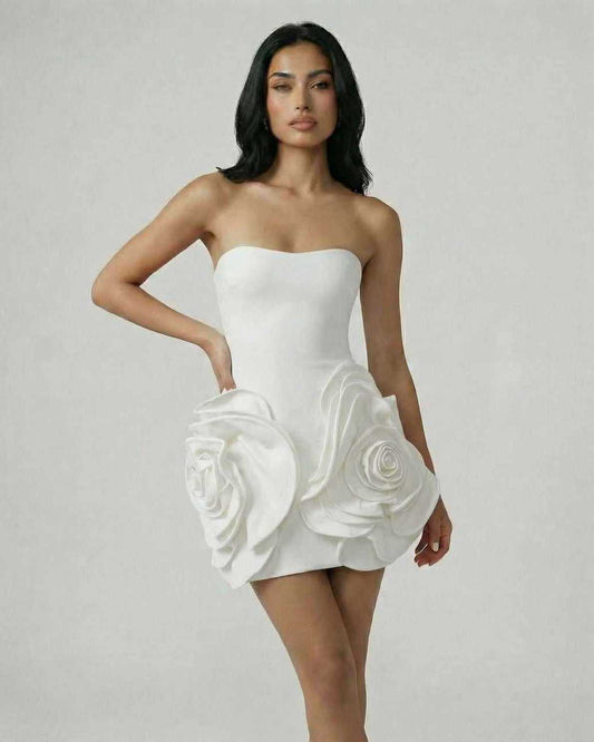 Celeste Mini Dress by Lauven, featuring oversized floral accents on a classic white strapless silhouette.