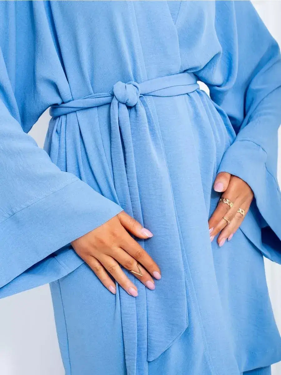 Celeste Suit Set by Lauven featuring an elegant soft blue oversized kimono robe with tied belt.