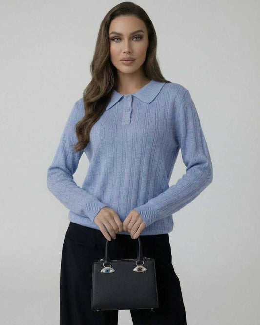Celeste Sweater by Lauven — Women’s blue knit sweater with collared design modeled by a woman holding a handbag.
