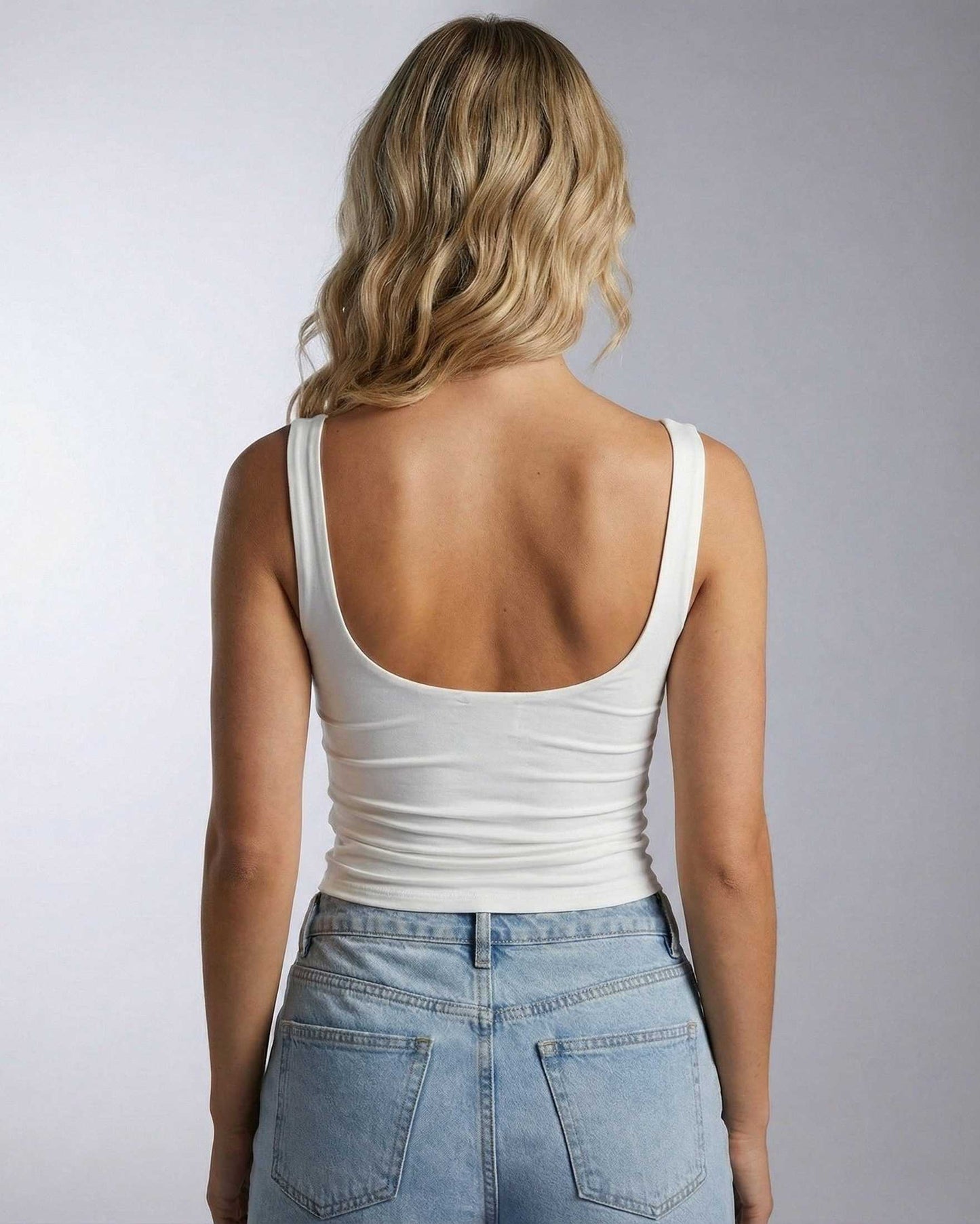 Back view of a woman wearing the Celeste Top by Lauven, showcasing its elegant square neckline and fitted style.