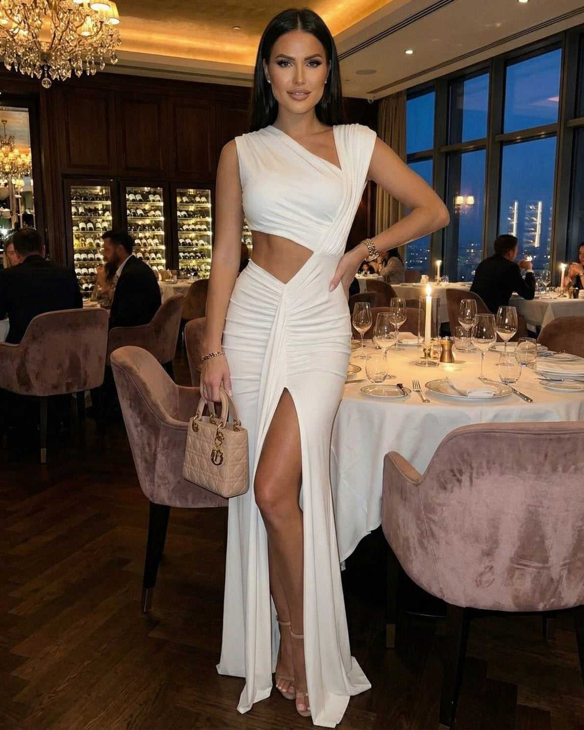 Celestine Maxi Dress by Lauven featuring a white asymmetrical cutout design, ankle-length sheath silhouette in an elegant dining setting.