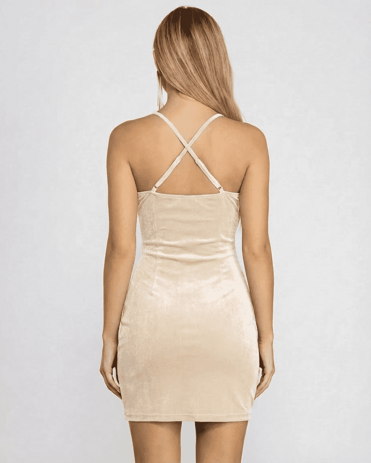 Back view of a model wearing Lauven Champagne Mini Dress, showcasing the elegant cowl neck and backless design.