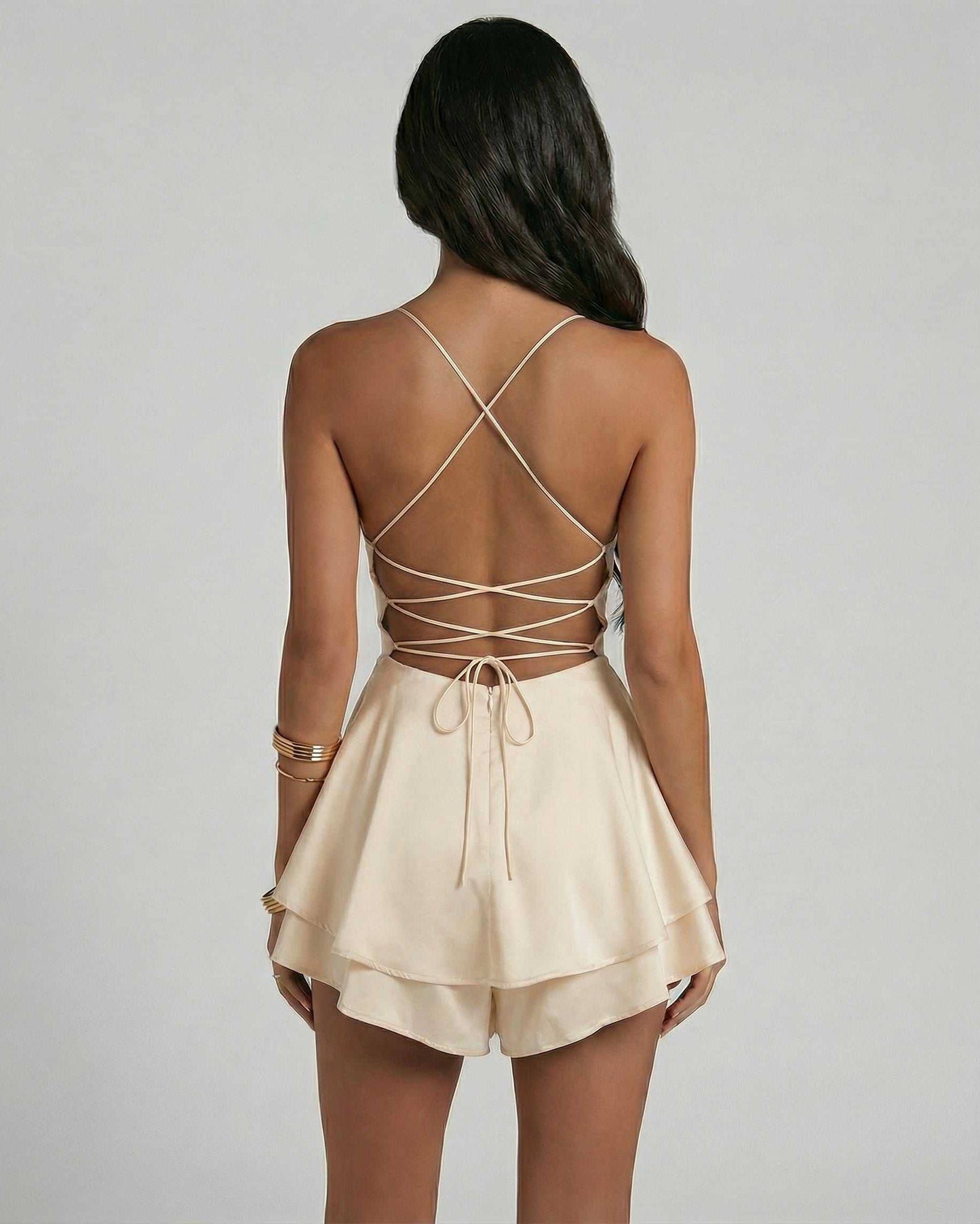 Back view of a woman wearing a Champagne Mini Dress by Lauven, showcasing delicate straps and an elegant A-line silhouette.
