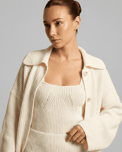 Elysia Mini Dress styled with a chic white knit cardigan from Lauven, highlighting a modern, sophisticated look.