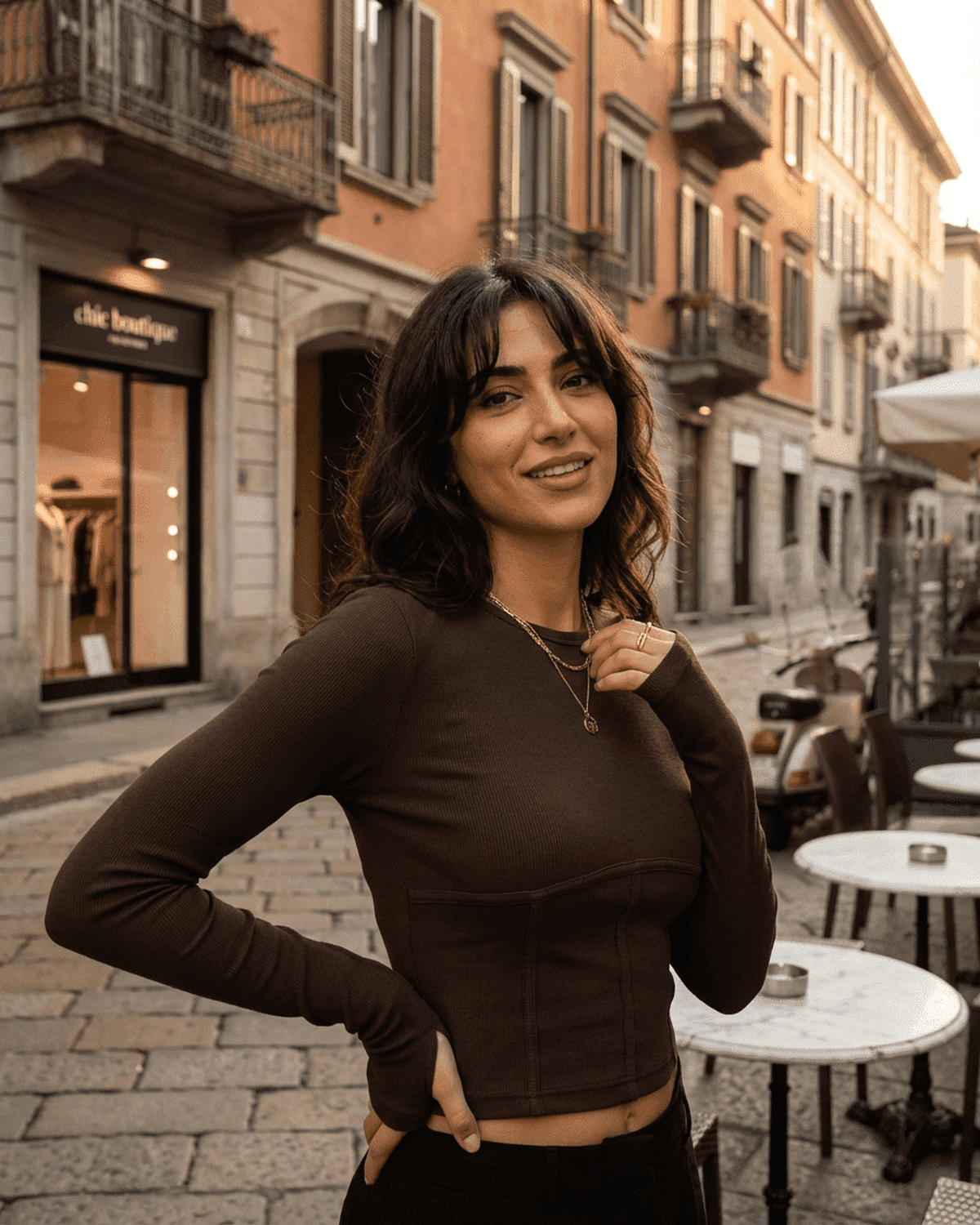 Woman wearing the Cocoa Corset Top by Lauven, showcasing a stylish long sleeve jersey crop in an urban setting.