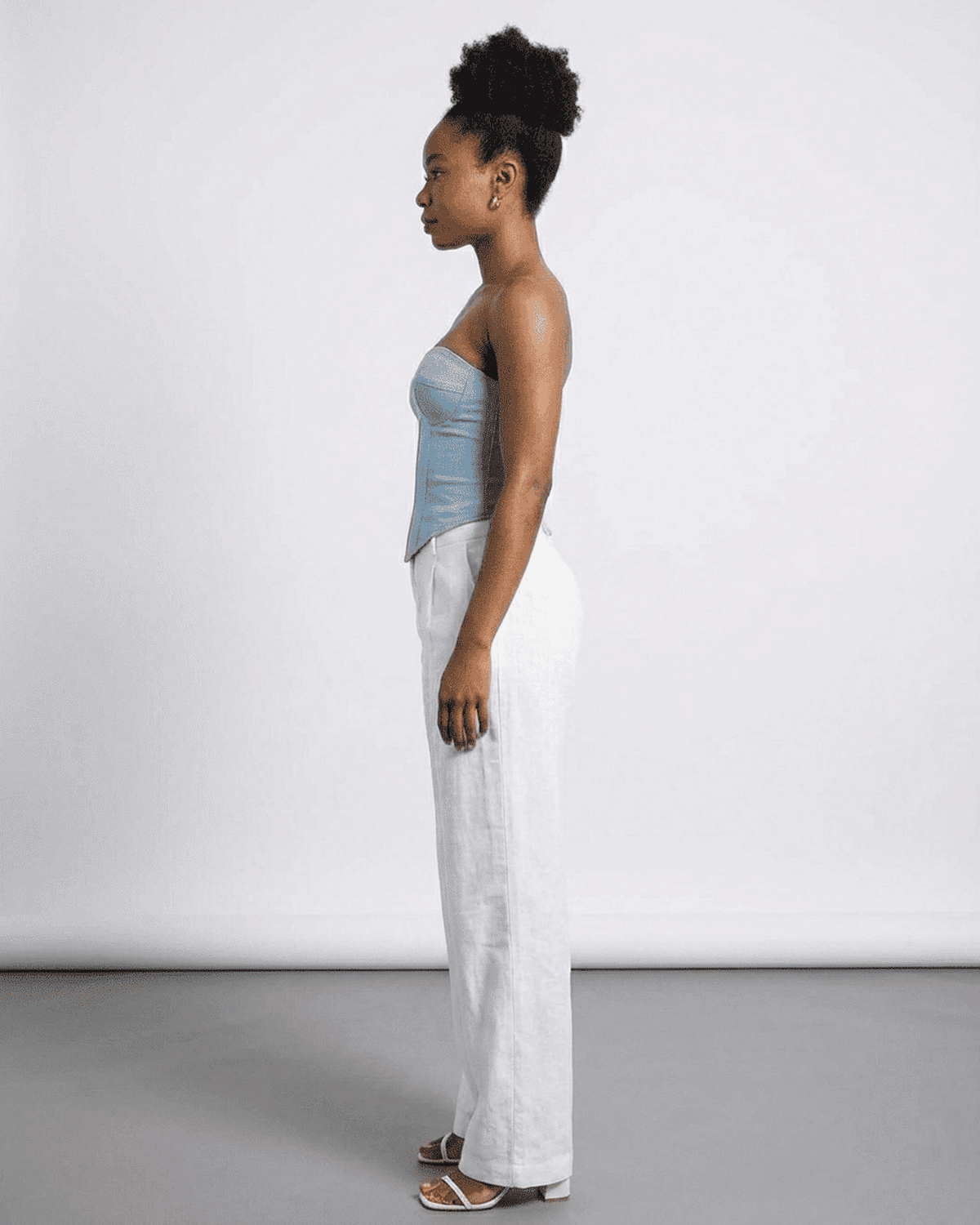 Denali Corset Top by Lauven, showcasing a blue faux denim cup bustier in a side profile view.