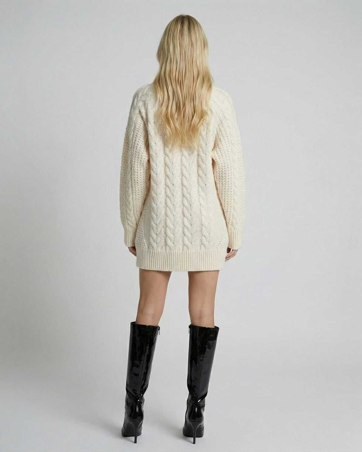 Back view of a model wearing the Eira Sweater by Lauven, showcasing its minimal cable-knit design and modern silhouette.