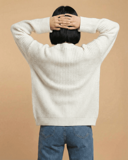 Back view of a woman wearing the Elara Cardigan by Lauven, showcasing its loose fit and knit texture.