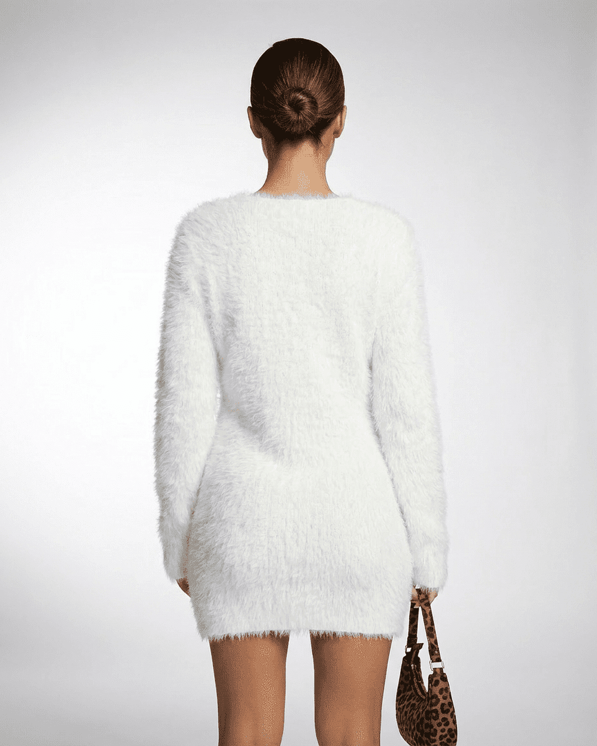Back view of a model wearing the Elara Sweater by Lauven, showcasing its soft, fuzzy texture and elegant design.