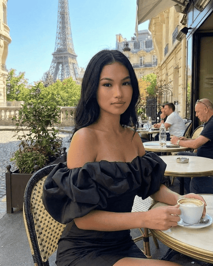 Elysia Mini Dress by Lauven worn in Paris, featuring ruffle trim and off-the-shoulder style with the Eiffel Tower backdrop.