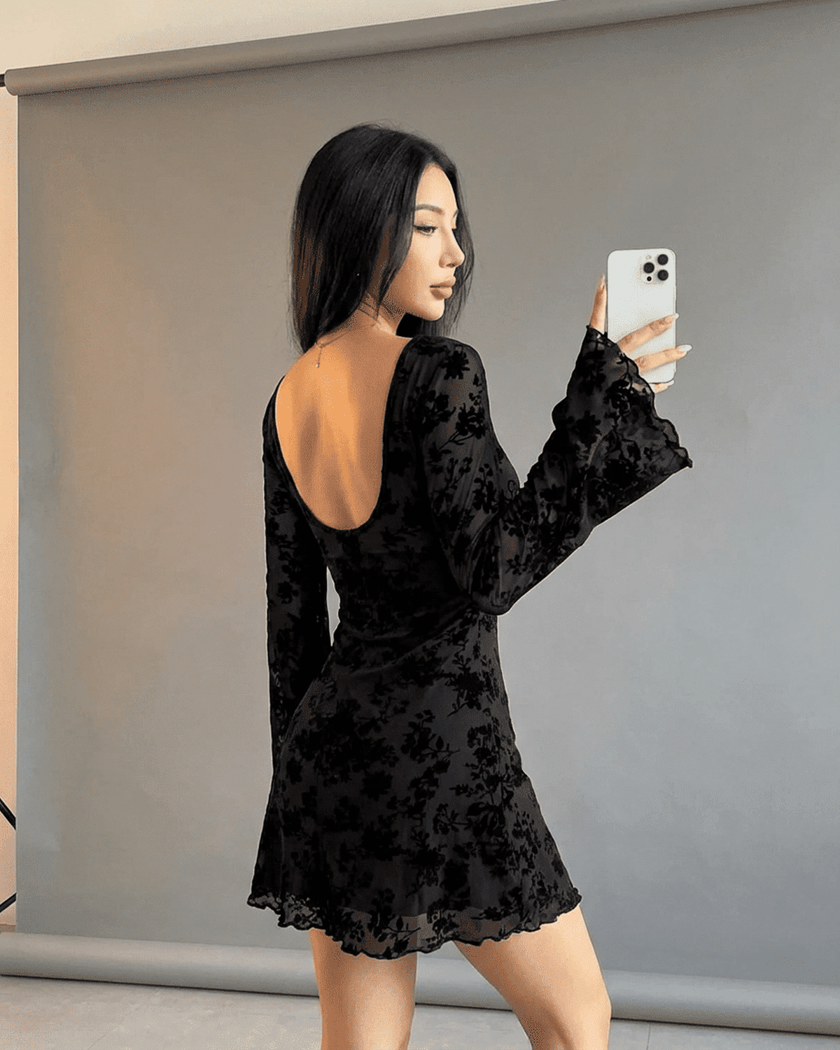 Fleur Mini Dress by Lauven, showcasing a backless design with flared sleeves and delicate floral details.