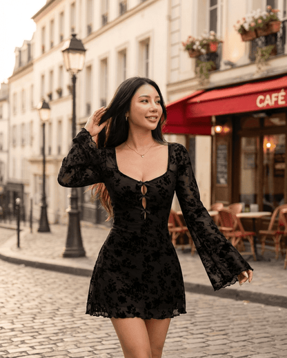 Fleur Mini Dress by Lauven featuring floral cutouts and flared sleeves in a charming street setting.