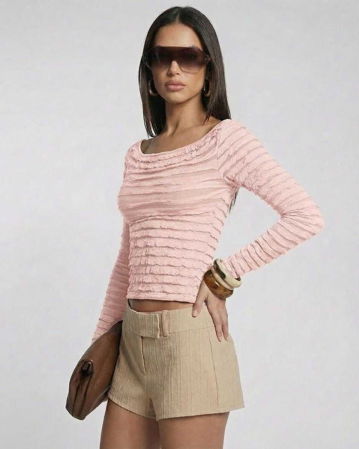 Women’s model wearing Florence Pullover by Lauven, a pink long sleeve slim fit top with textured design.