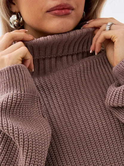 Close-up of model showcasing the Florence Sweater by Lauven, featuring an oversized knit design and turtleneck collar.