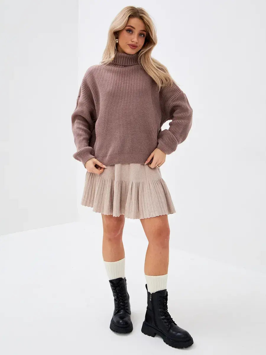 Florence Sweater by Lauven, oversized knit with turtleneck, styled with a skirt and boots.