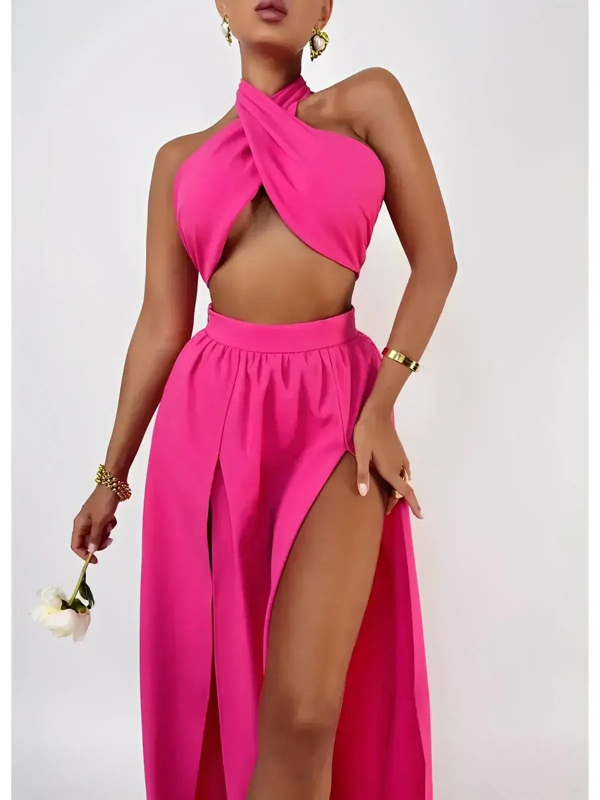 Elegant model showcasing Fuchsia Breeze Set by Lauven, featuring a criss-cross top and flowing skirt in bold fuchsia.