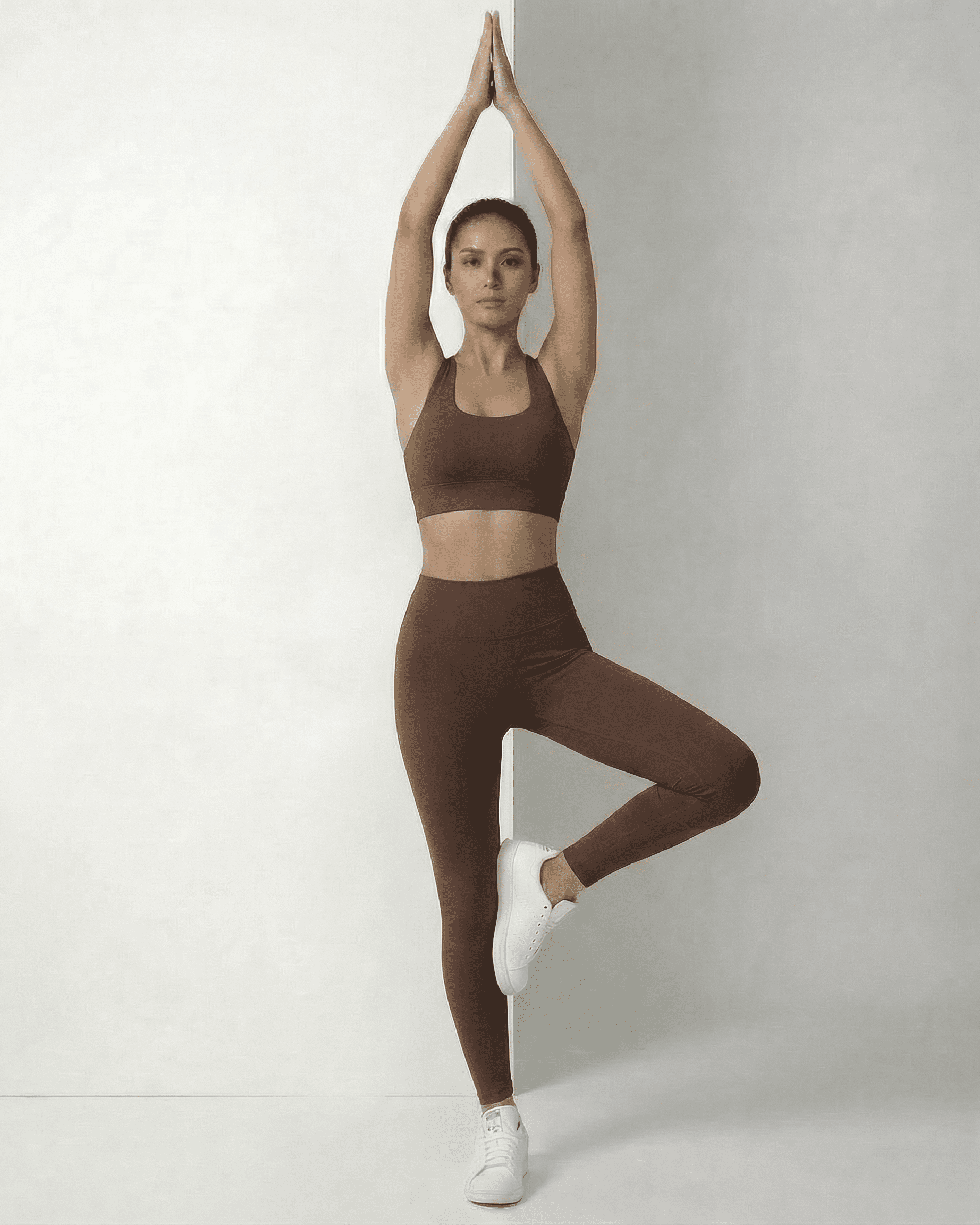 Woman practicing yoga in sleek Hazel Leggings and matching top by Lauven, showcasing comfort and style.