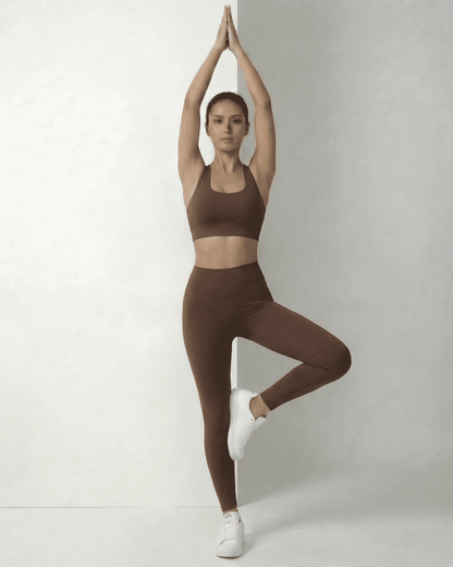 Woman practicing yoga in sleek Hazel Leggings and matching top by Lauven, showcasing comfort and style.