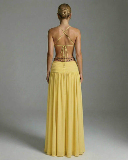 Back view of the Heliora Maxi Dress by Lauven, showcasing its yellow hue and elegant floor-length design.