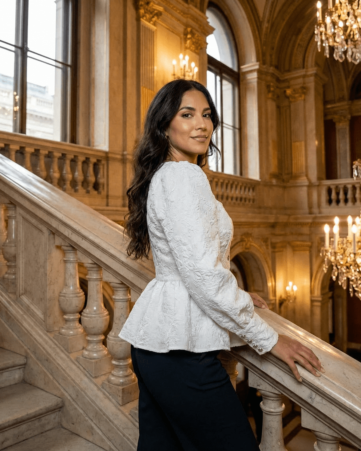 Ivory Corset Top modeled by a woman in an elegant setting, featuring jacquard fabric with puff sleeves and a square neckline.