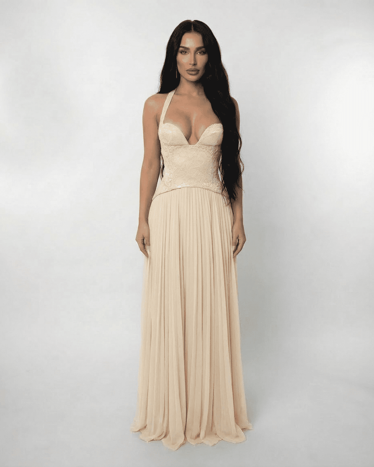Ivory Maxi Dress by Lauven featuring a lace halter bodice and pleated skirt, showcasing elegant flowing lines.