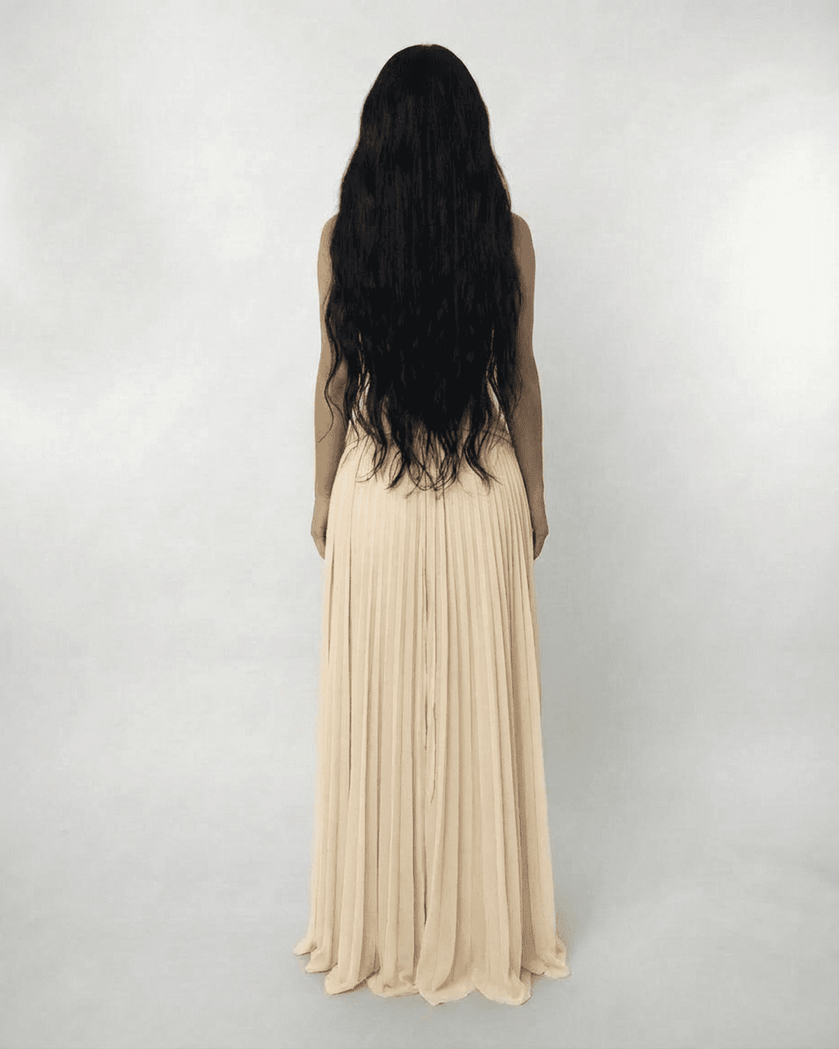 Ivory Maxi Dress by Lauven, showcasing a lace halter bodice and pleated maxi skirt from the back.