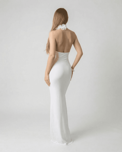 Lumière Maxi Dress by Lauven - Back view of a white deep V neck backless maxi dress with 3D floral detail.