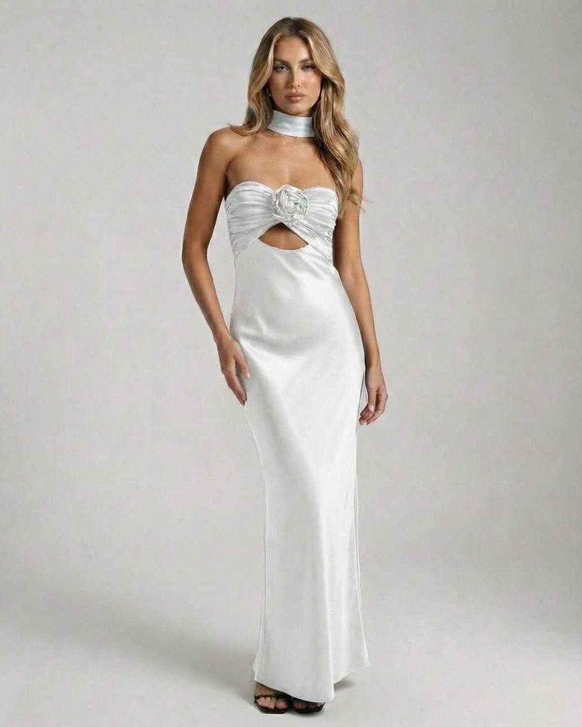 Luna Maxi Dress by Lauven, an elegant white satin fit and flare evening gown with strapless neckline and rose detail.