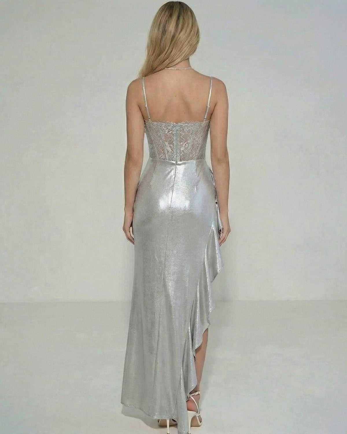 Luna Maxi Dress by Lauven featuring a metallic sheer lace bodice and ruffled asymmetrical skirt, shown from the back.