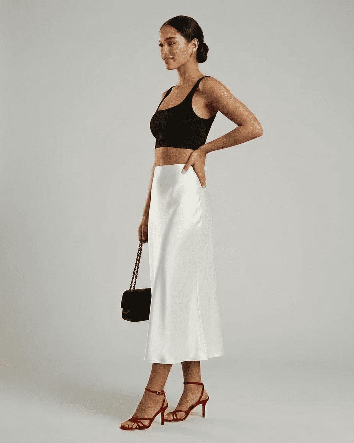 Model showcasing the Luna Midi Skirt by Lauven, featuring an elegant satin design and refined silhouette.