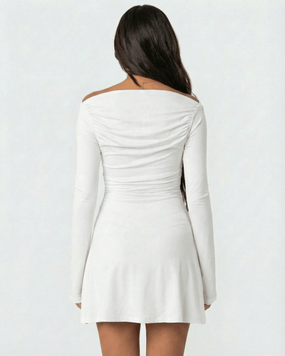 Luna Mini Dress by Lauven, showcasing a stylish asymmetrical neckline and long sleeves in a classic white color.