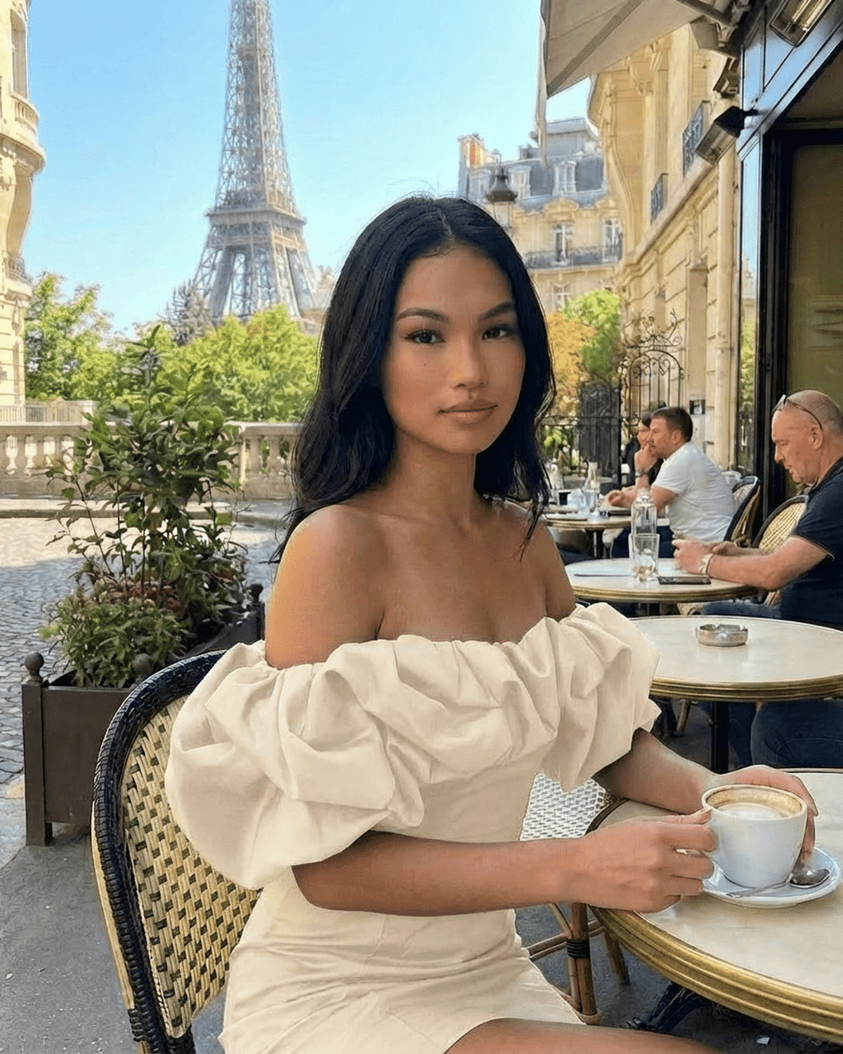 Lauven Luna Mini Dress with Off-The-Shoulder Ruffle Detail, styled in Parisian cafe setting.