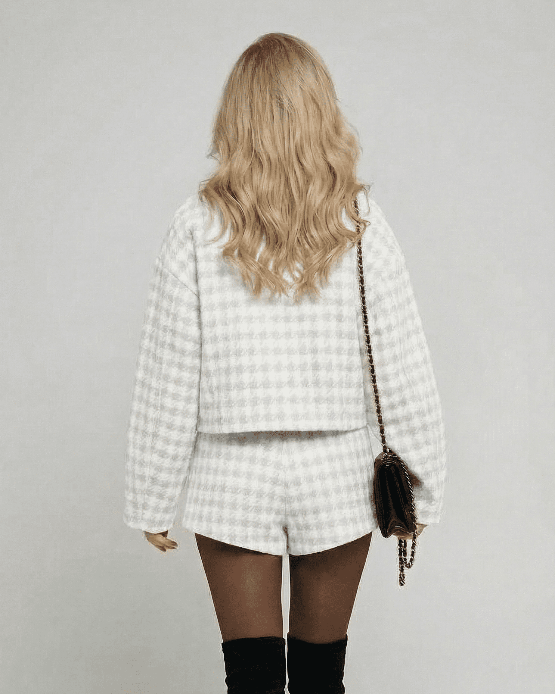 Luna Set by Lauven showing a woman from the back in elegant two-piece tailored shorts and a chic long-sleeve top.