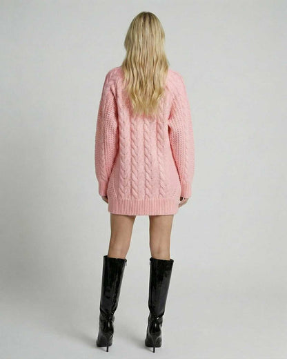 Back view of a model wearing the soft pink Luna Sweater by Lauven, showcasing its stylish cable-knit design.