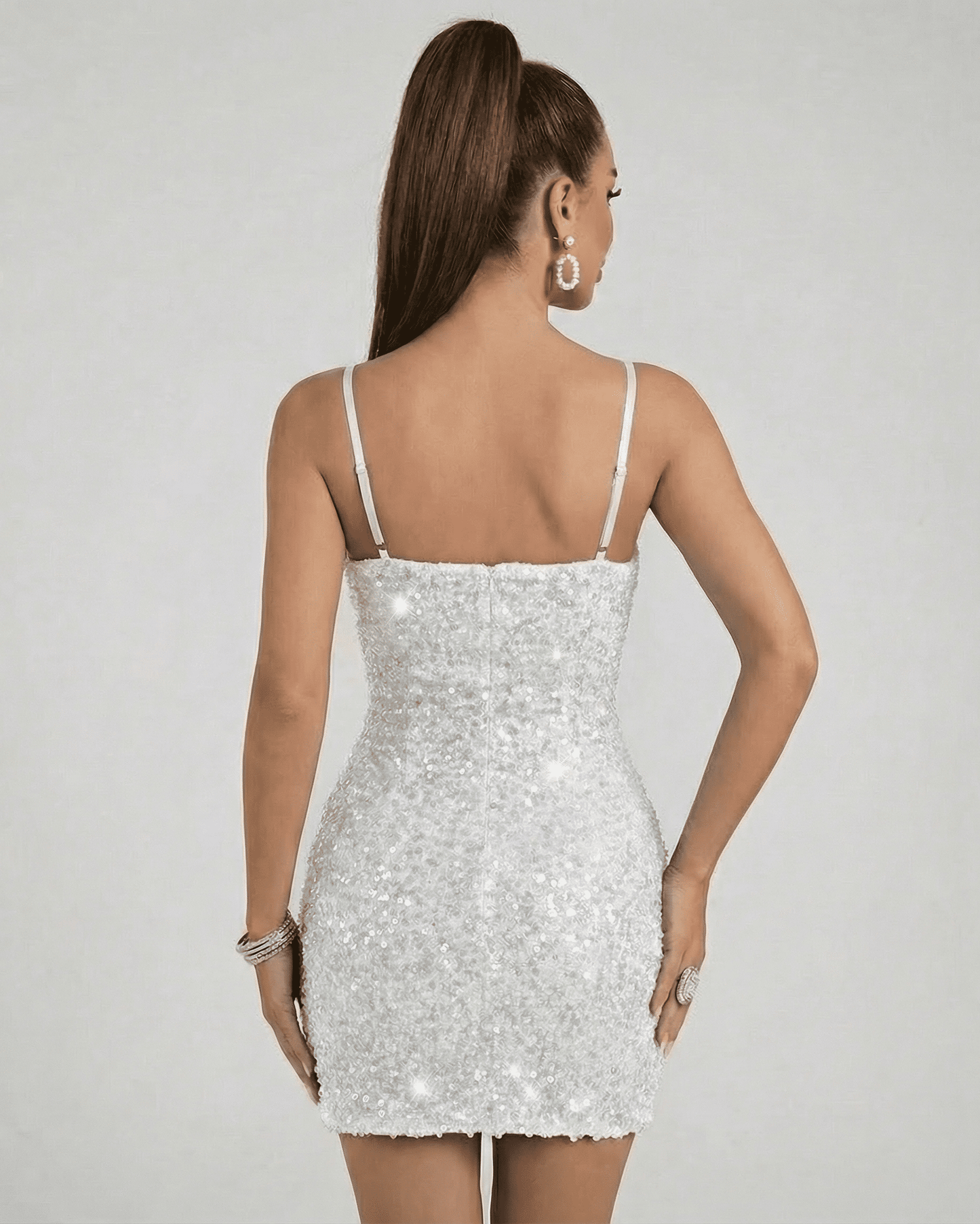 Lunara Sequin Dress by Lauven, showcasing a mini bodycon silhouette with a dazzling white sequin finish from the back.