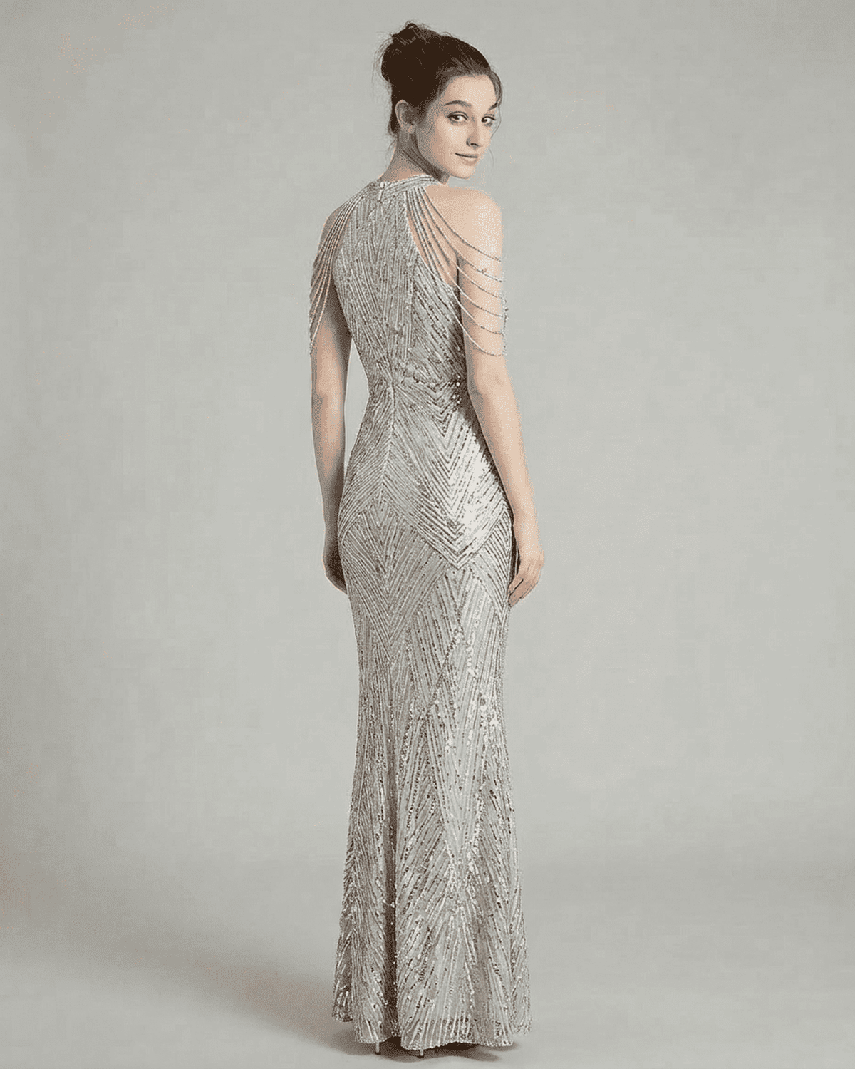 Luxe Maxi Dress by Lauven features intricate sequin patterns and elegant beaded shoulder drapes, showcasing a glamorous look.