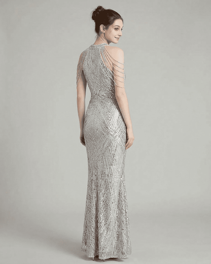 Luxe Maxi Dress by Lauven, showcasing a silver sequin mermaid gown with elegant beaded shoulder drapes.