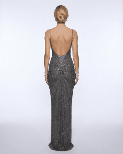Back view of a woman wearing the Lyra Maxi Dress from Lauven, showcasing its metallic crystal embellishments and elegant silhouette.