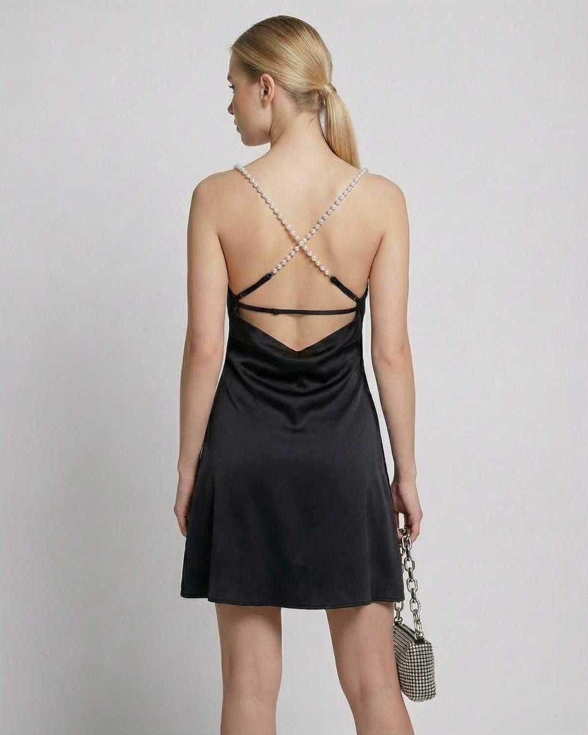 Back view of the Lyra Mini Dress by Lauven showcasing satin fabric and pearl strap detail.