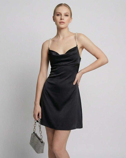 Lyra Mini Dress in black satin with draped neckline and pearl strap detail by Lauven.