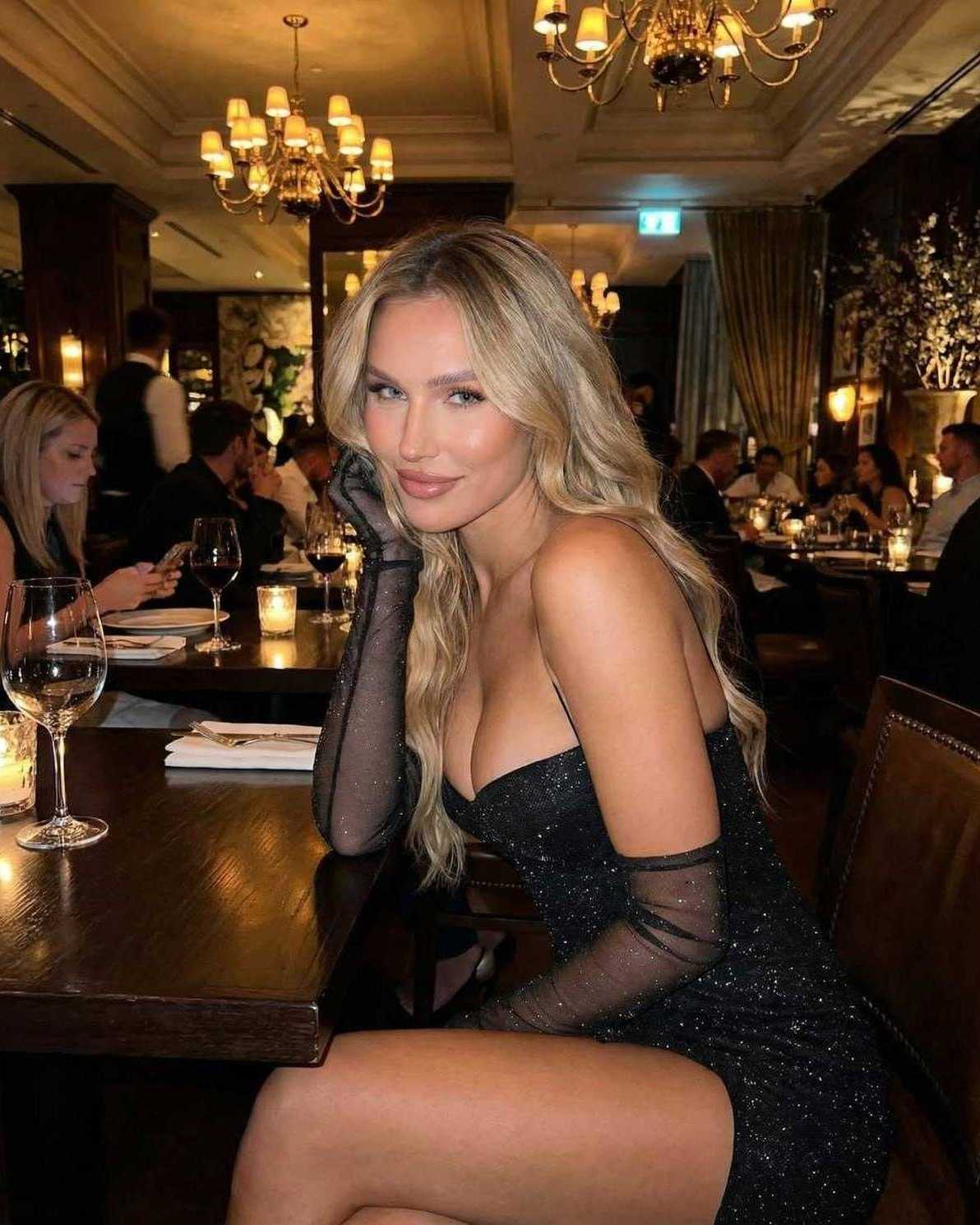 Lyra Mini Dress by Lauven worn in a stylish restaurant setting, featuring a bodycon silhouette and sequin details.