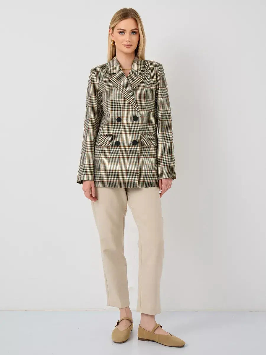 Model wearing a Maple Blazer by Lauven, showcasing a chic oversized brown checked design.