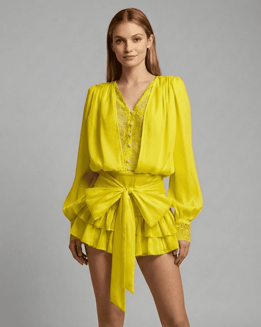 Lauven Marigold Mini Dress featuring lace detail, V-neck, and tiered silhouette in vibrant yellow.